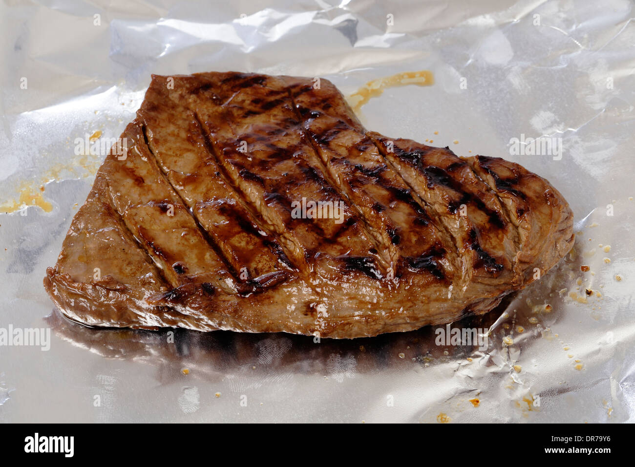 Grilled flank steak or "london broil" resting on tinfoil Stock Photo