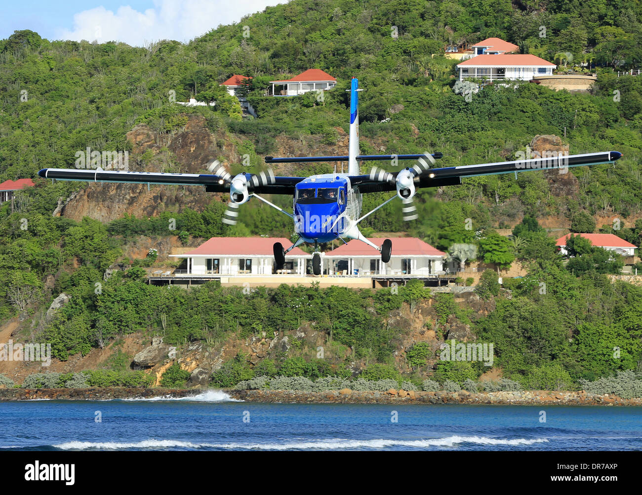 A Winair Twin Otter from St. Martin on short finals to Runway 28 at St. Barth's. Stock Photo