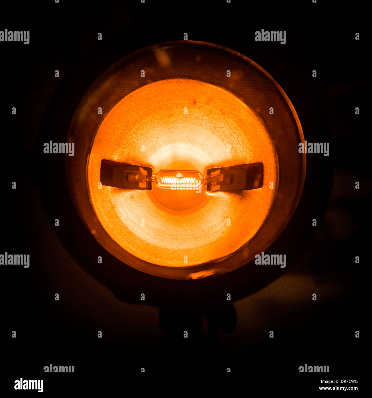 An incandescent electric light bulb filament glowing red hot Stock