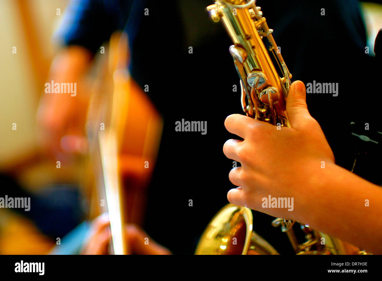 musicians playing saxophone and guitar Stock Photo