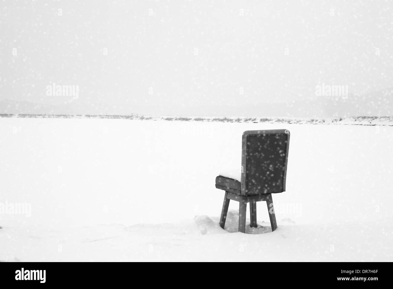 In snowy day, a chair waiting for someone Stock Photo