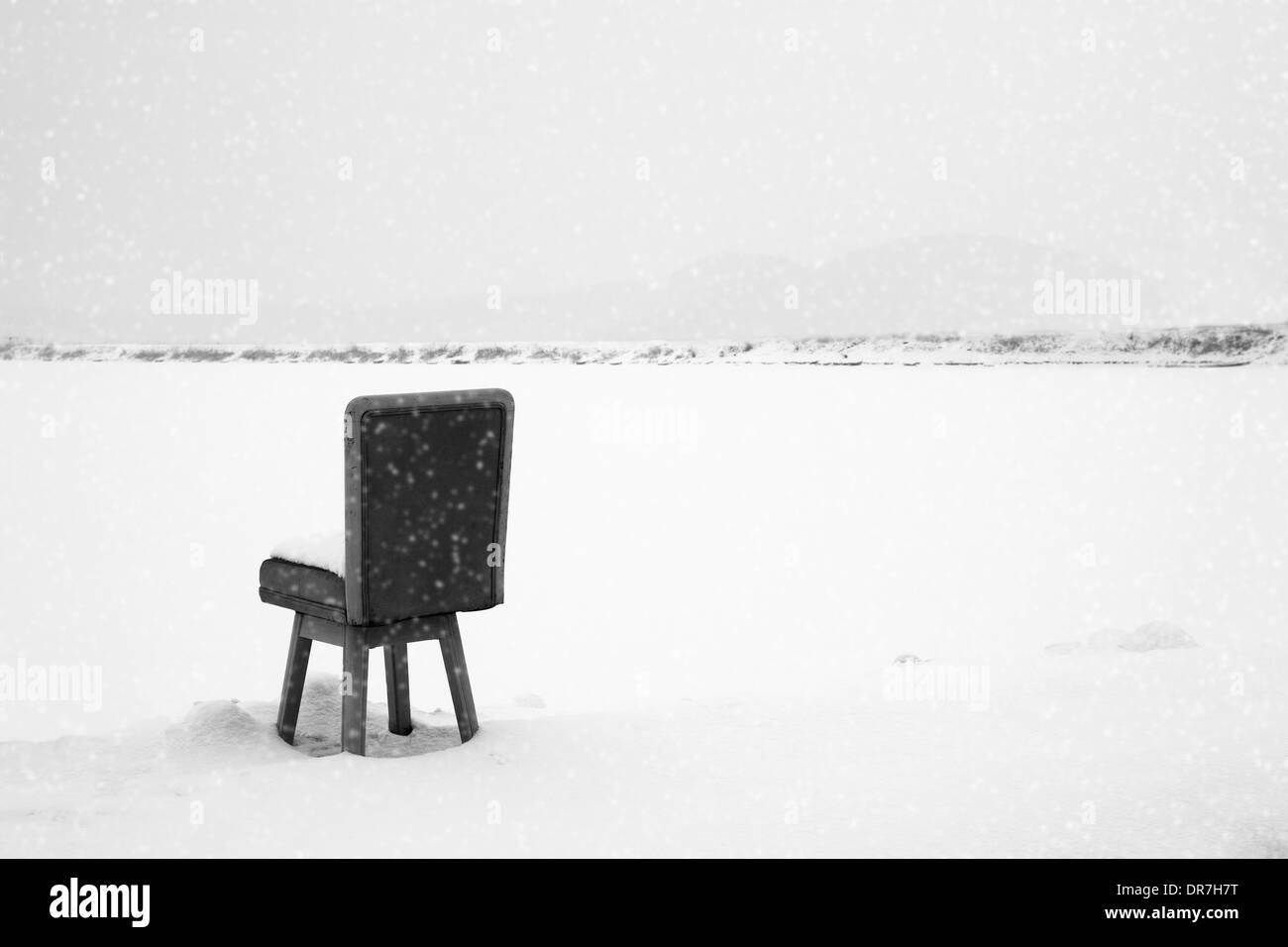 In snowy day, a chair waiting for someone Stock Photo