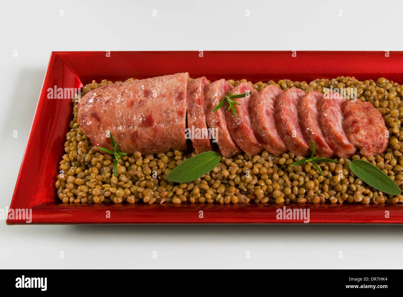 Cotechino (boiled pork sausage) on lentils, Italian cooking, Christmas food Stock Photo