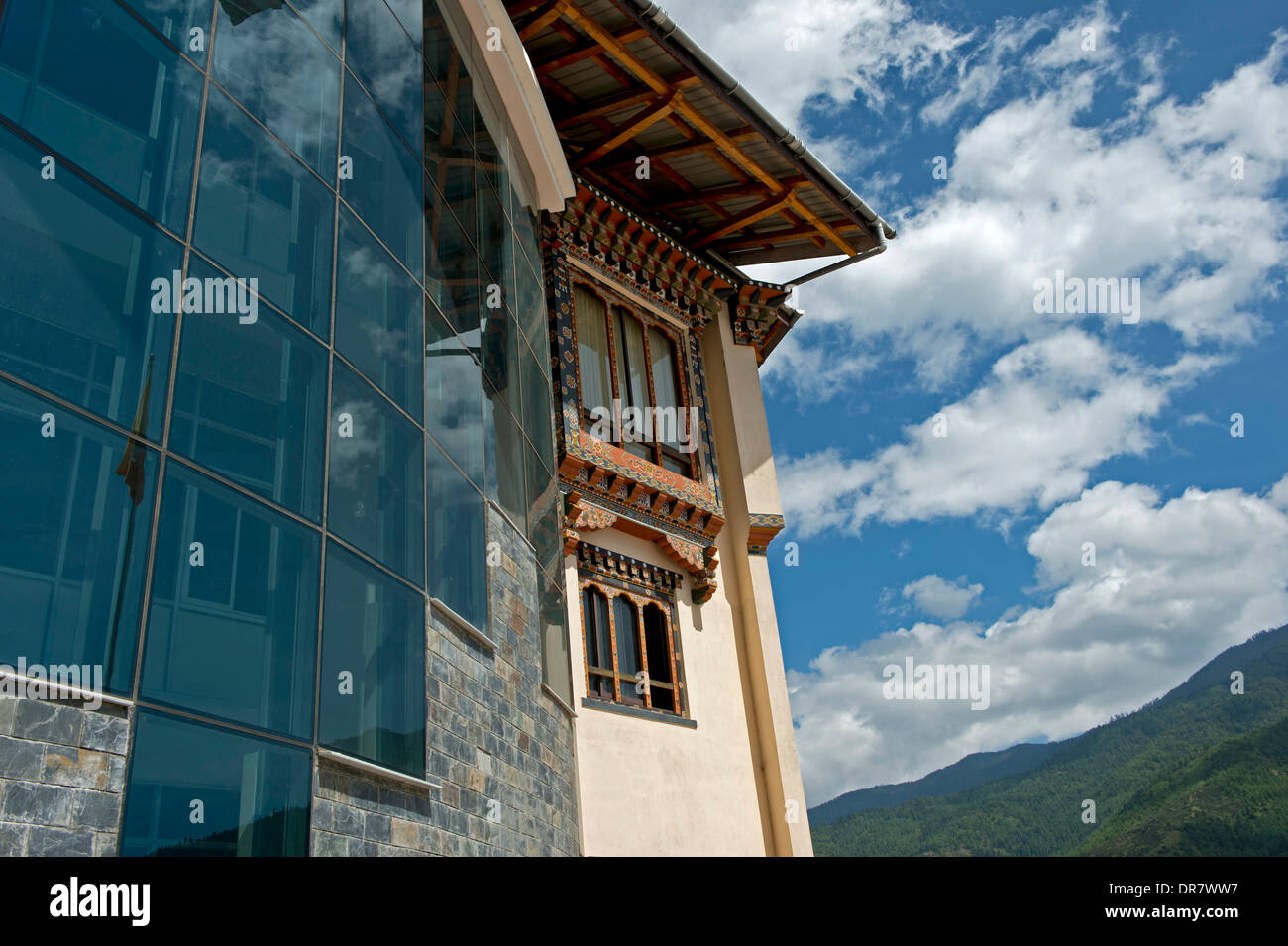 Modern glass facade and traditional-style windows at the headquarters of the Royal University of Bhutan, Thimphu, Bhutan Stock Photo