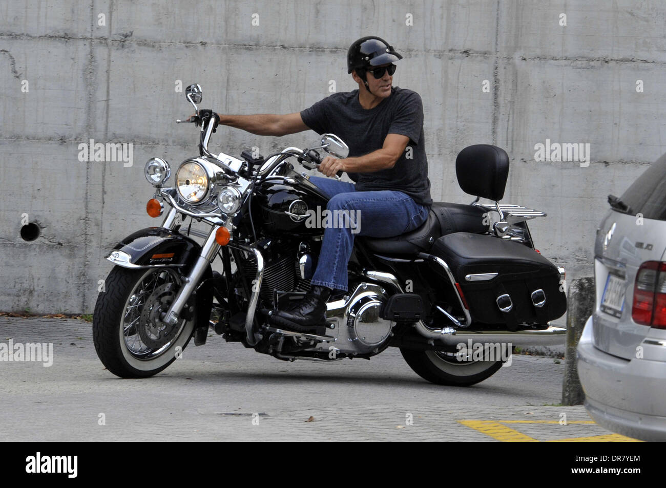 George Clooney riding a Harley Davidson motorcycle in Milan Milan