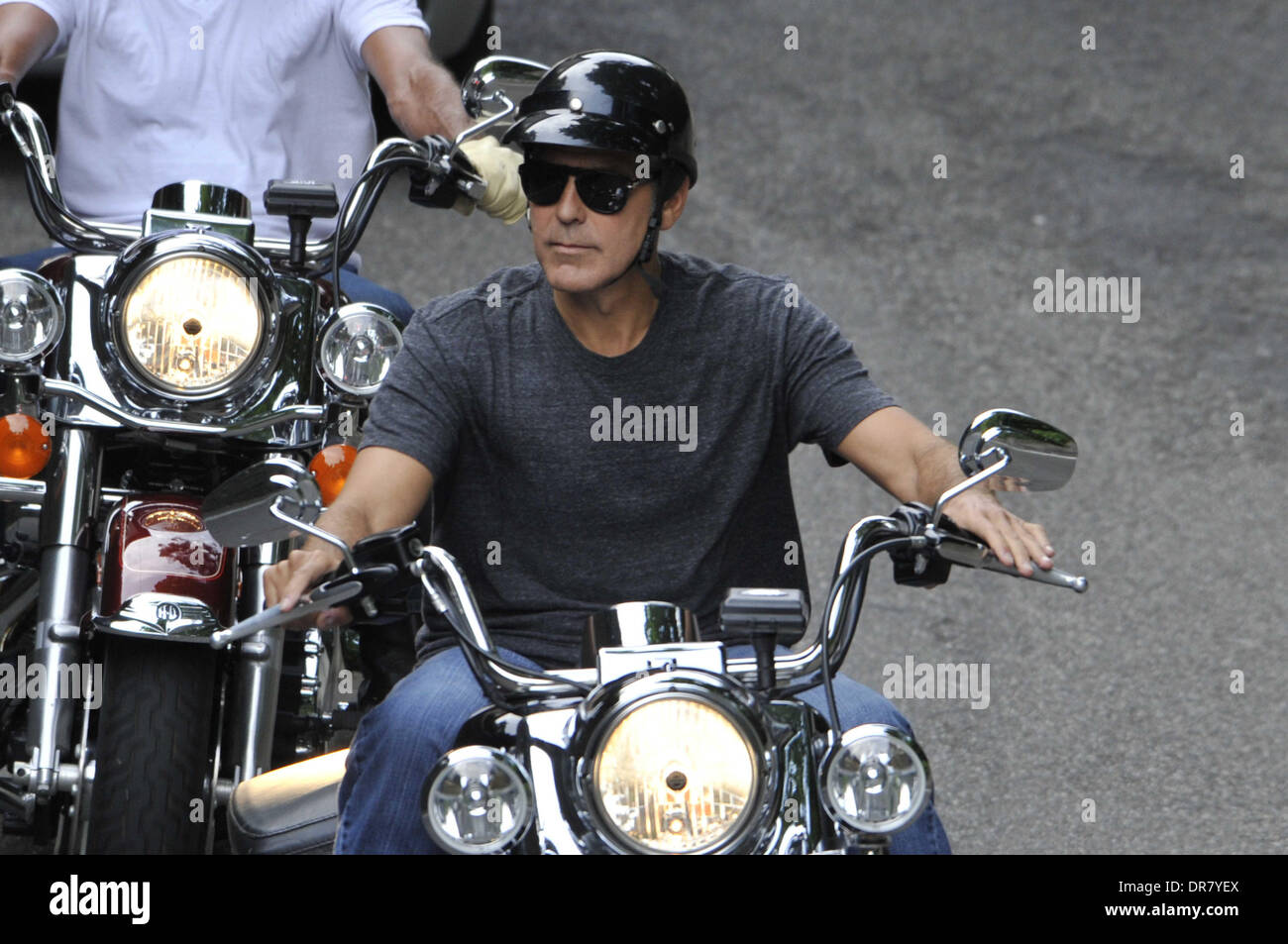 George Clooney riding a Harley Davidson motorcycle in Milan Milan, Italy -  19.06.12 Stock Photo - Alamy