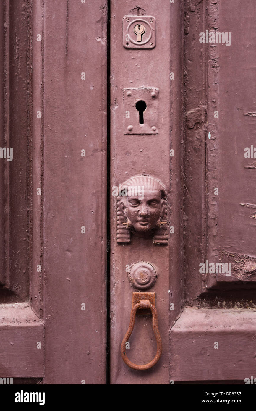 Egyptian head style door decoration and keyholes on old front door in Santa Cruz, La Palma, Canary Islands, Spain Stock Photo