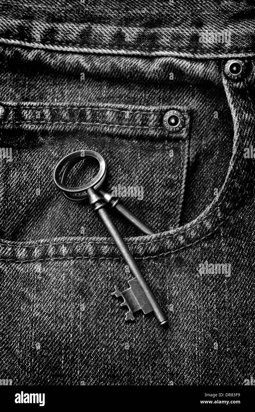 Old jeans with old antique key in pocket Stock Photo