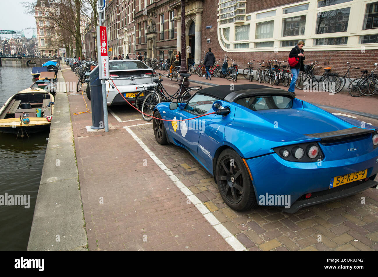Electric car at charging point in Amsterdam, Netherlands Stock Photo