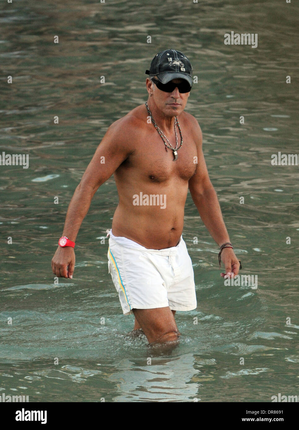 The singer Bruce Springsteen doing paddlesurf on a beach on holiday in Mallorca in 2013. Stock Photo
