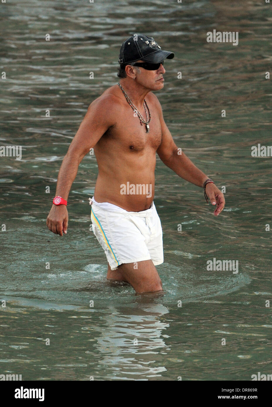 The singer Bruce Springsteen doing paddlesurf on a beach on holiday in Mallorca in 2013. Stock Photo