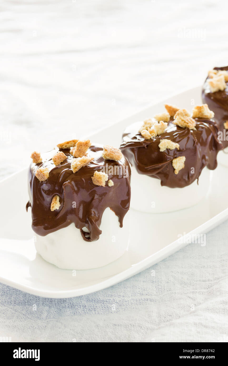 Traditional s'mores deconstructed as marshmallows dipped in milk