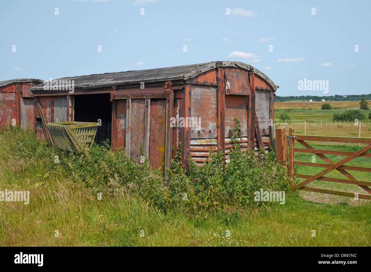 Old railway rolling stock used for agricultural storage. Walberswick, Suffolk, England. Stock Photo