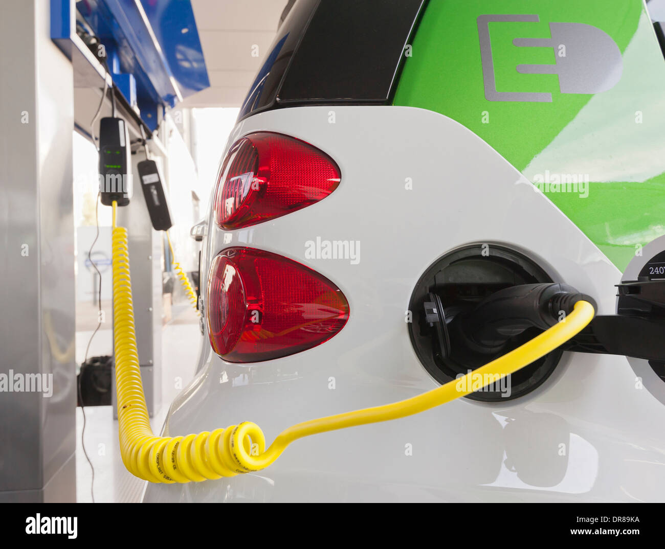 Electric vehicle charging at charge station Stock Photo