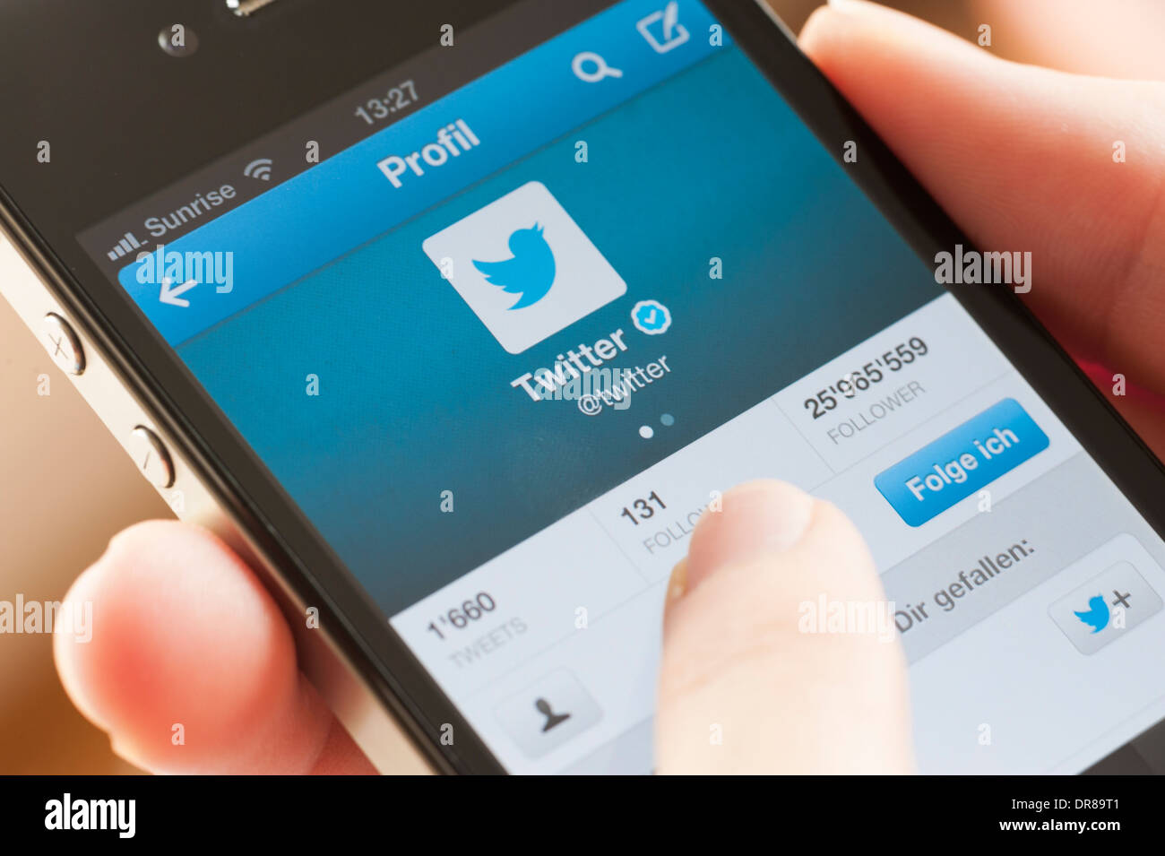 Close-up of a smartphone display showing the profile picture of Twitter's own Twitter account. Stock Photo