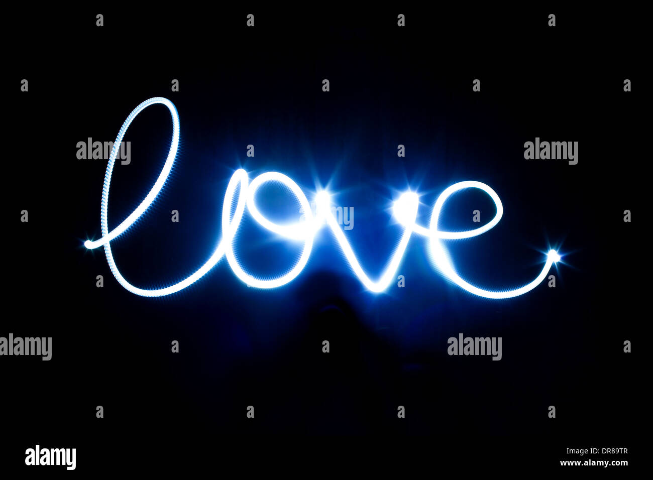 Glowing inscription LOVE on a black background Stock Photo