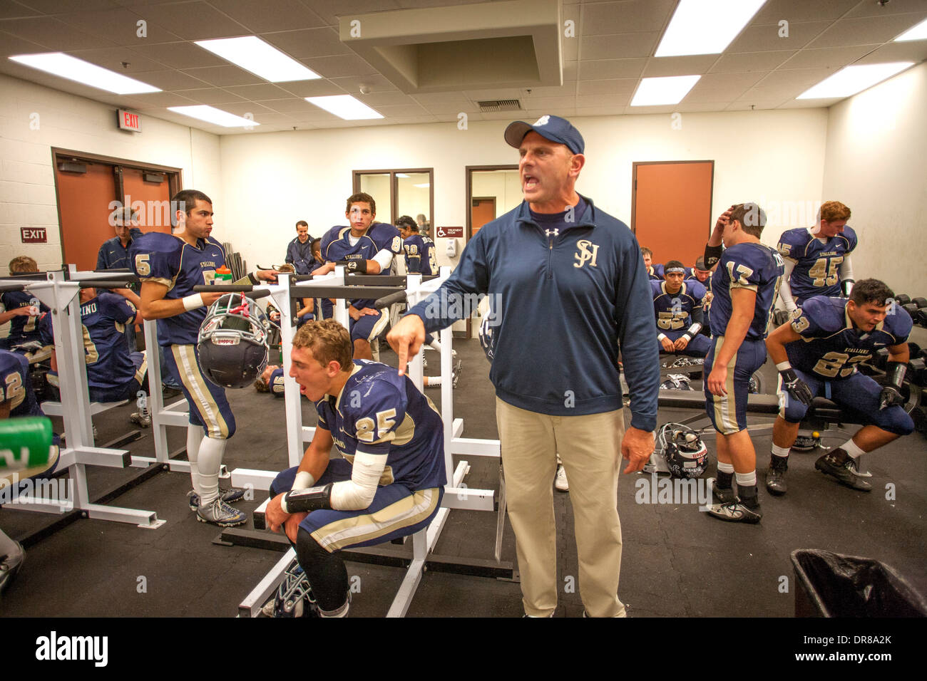 A high school football coach inspires his players during half time at a game in San Juan Capistrano, CA. Stock Photo