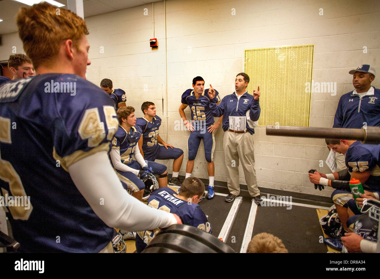 A high school football coach inspires his players during half time at a game in San Juan Capistrano, CA. Stock Photo