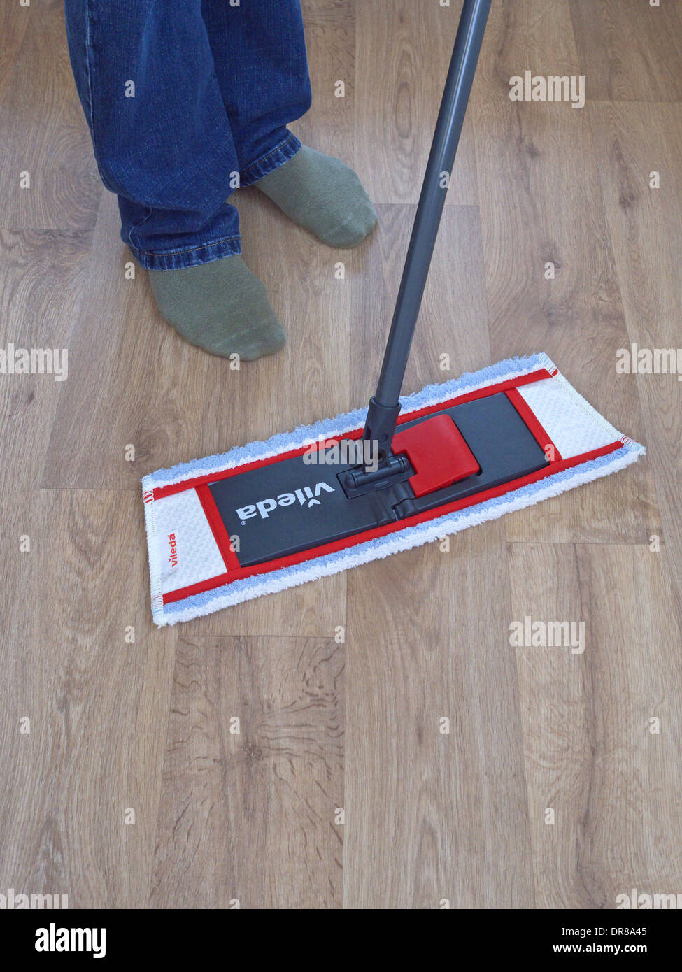 Man Using a Vileda Mop on a Vinyl Wood Effect Floor, UK MODEL RELEASED Stock Photo