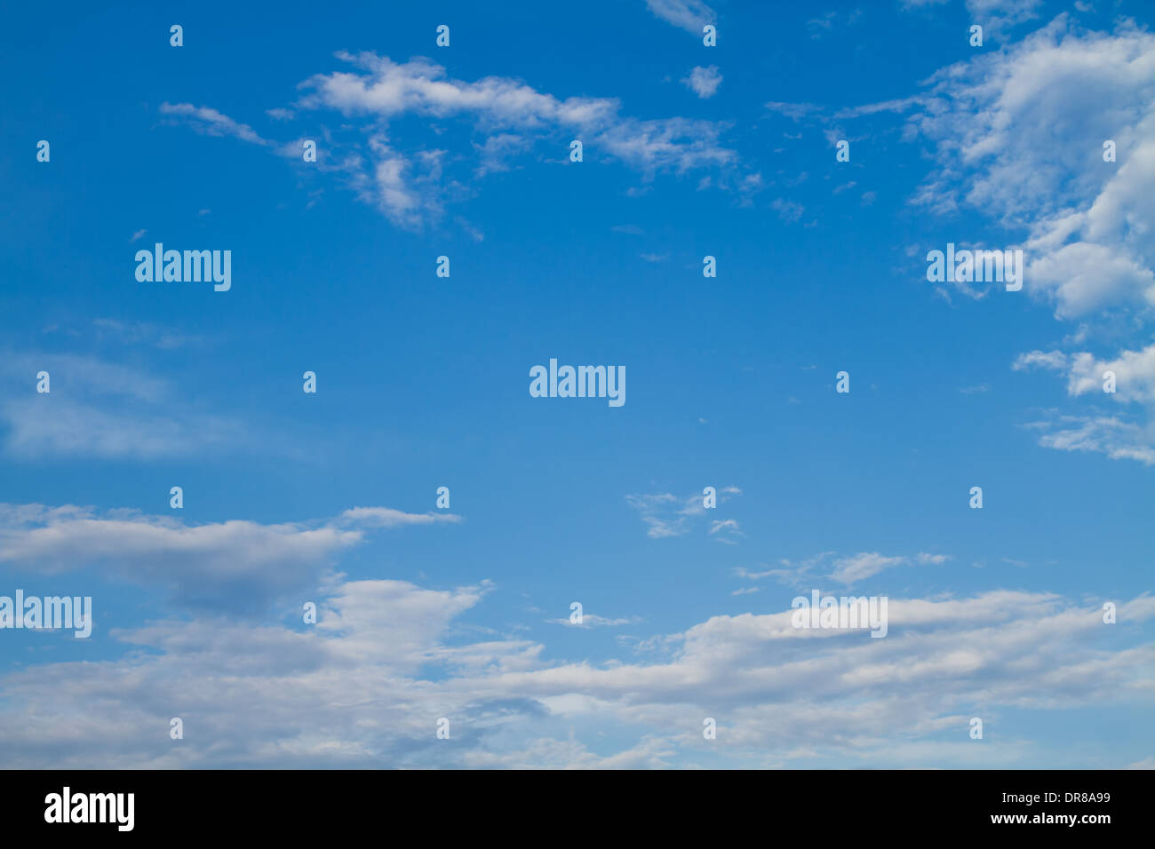 Puffy white clouds set against a perfect blue sky. Stock Photo