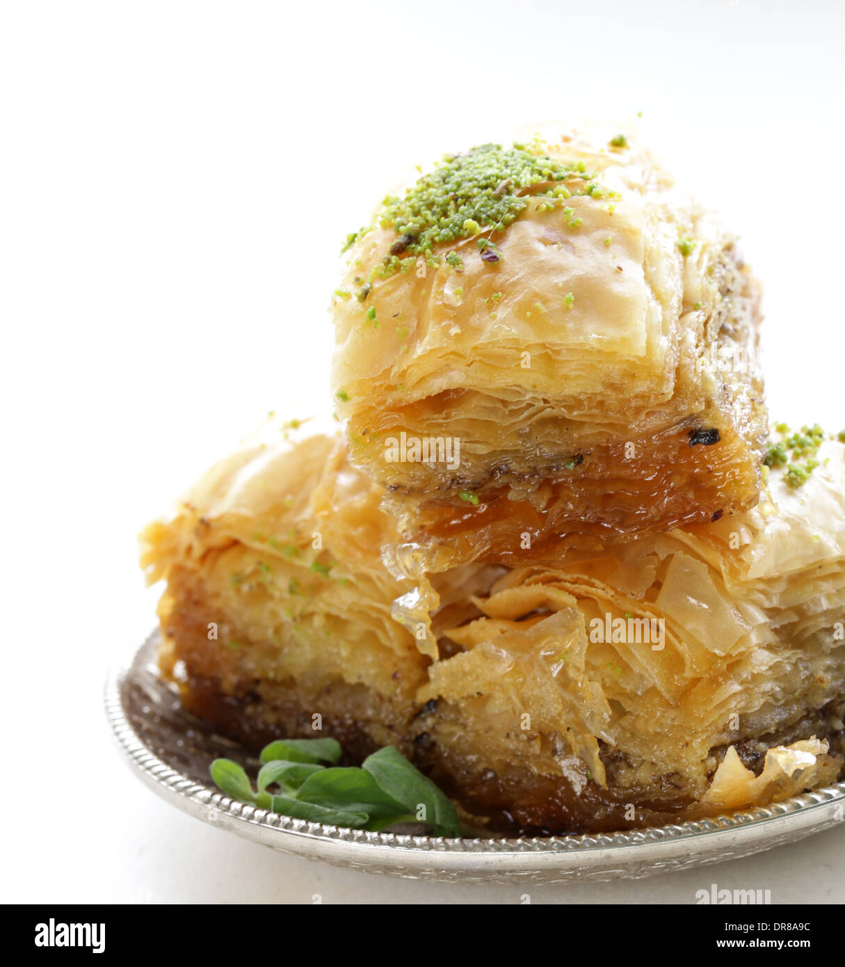 Turkish arabic dessert baklava with honey and nuts on a silver plate ...