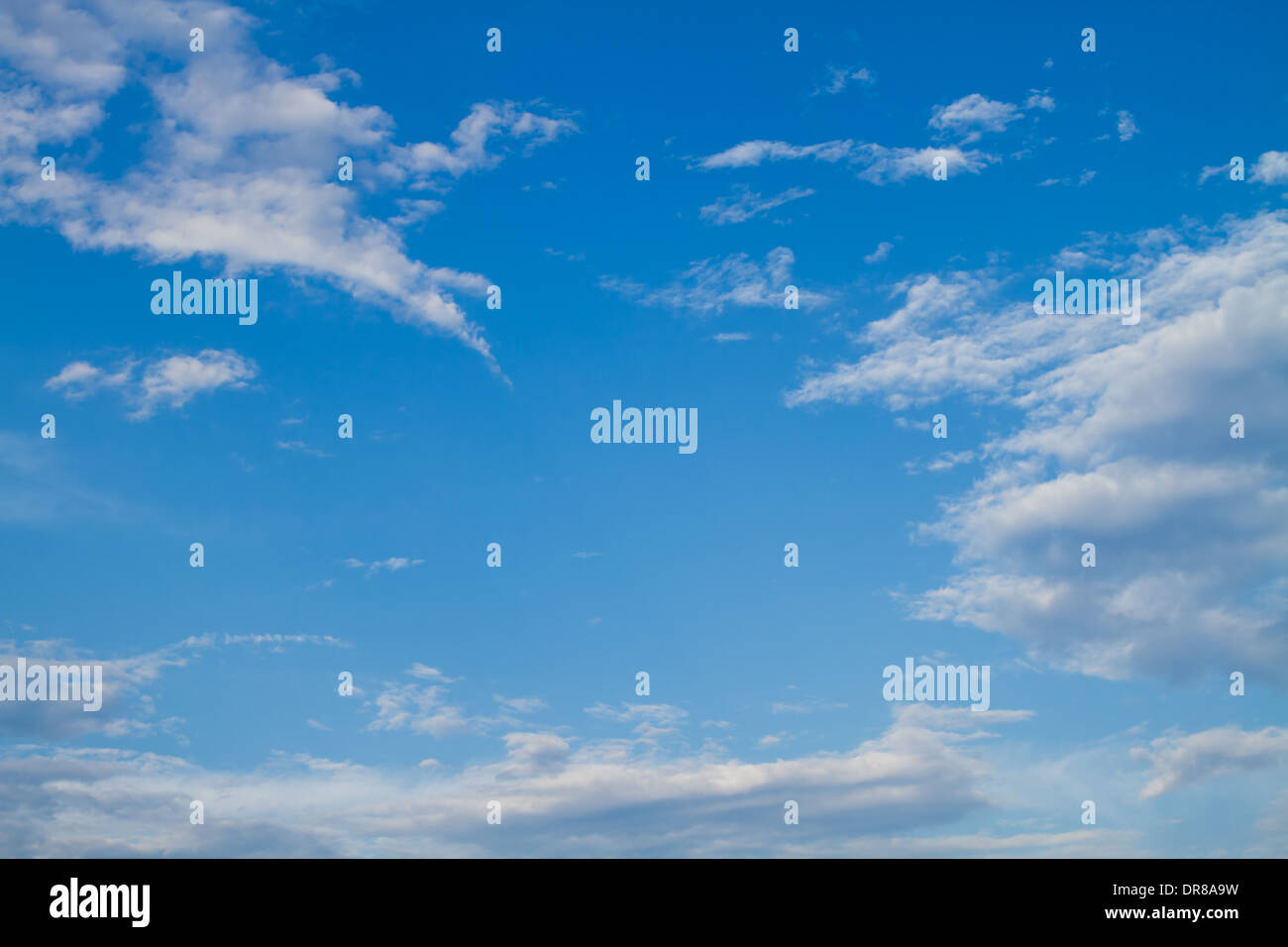 Puffy white clouds set against a perfect blue sky. Stock Photo