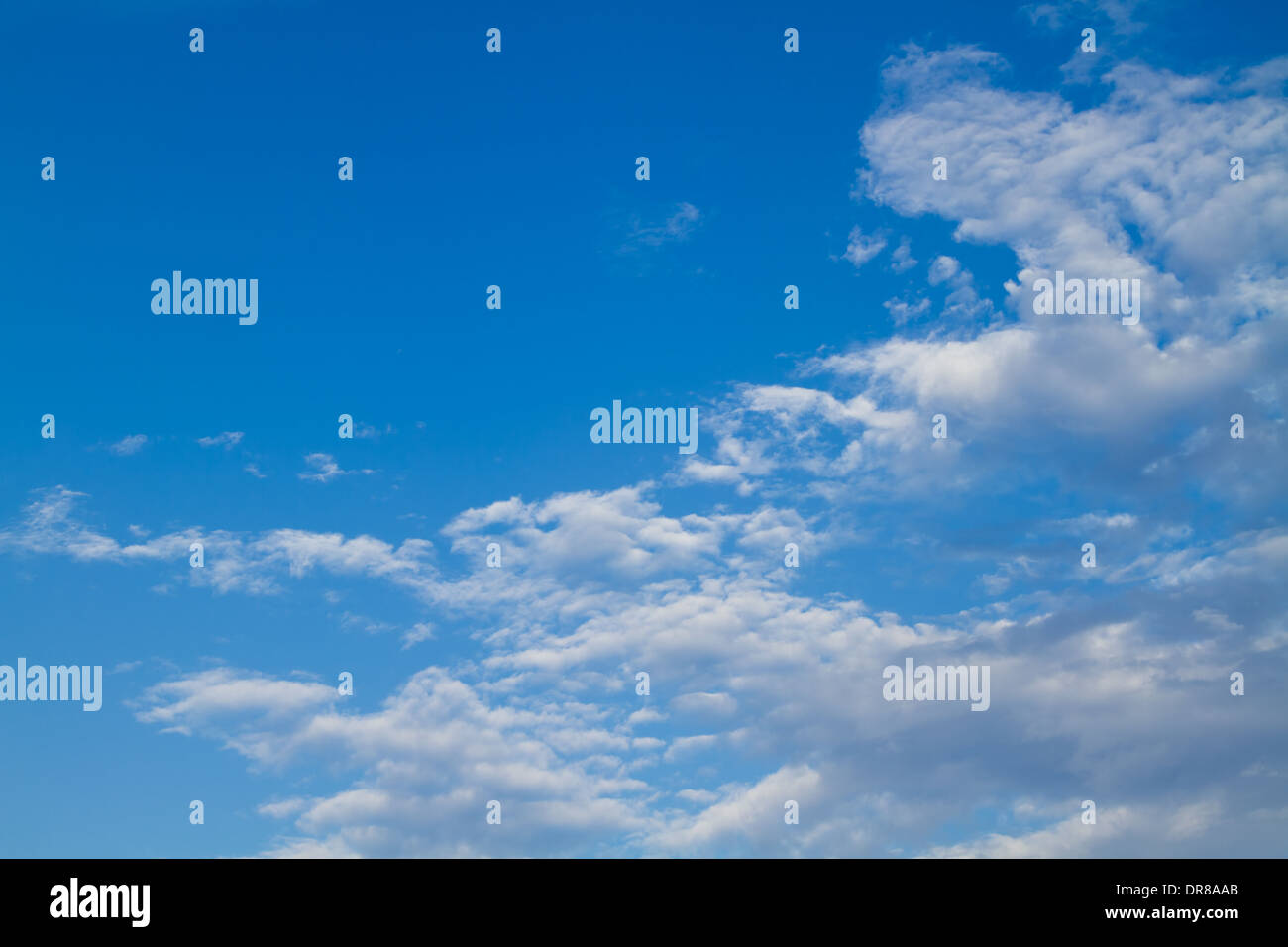 Puffy white clouds set against a perfect blue sky Stock Photo - Alamy