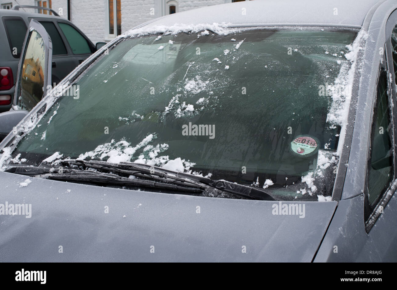 Clearing car of ice cold winters morning Stock Photo