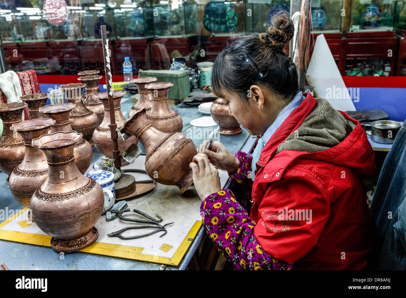 Female worker in China;Shanghai;Ceramic Factory painting and designing vases for sale to tourists.factory Stock Photo