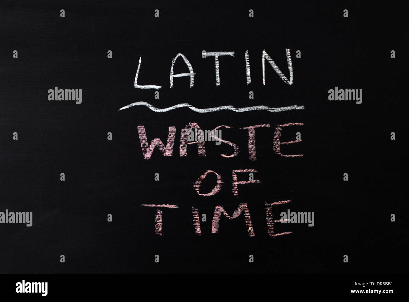 chalk writing -  Latin waste of time. - words written on blackboard. Stock Photo