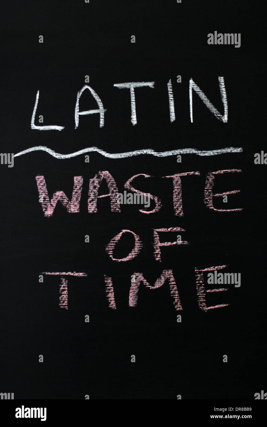 chalk writing -  Latin waste of time. - words written on blackboard. Stock Photo