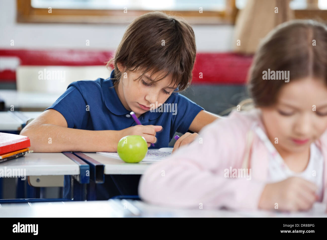 Schoolboy Drawing In Classroom Stock Photo - Alamy