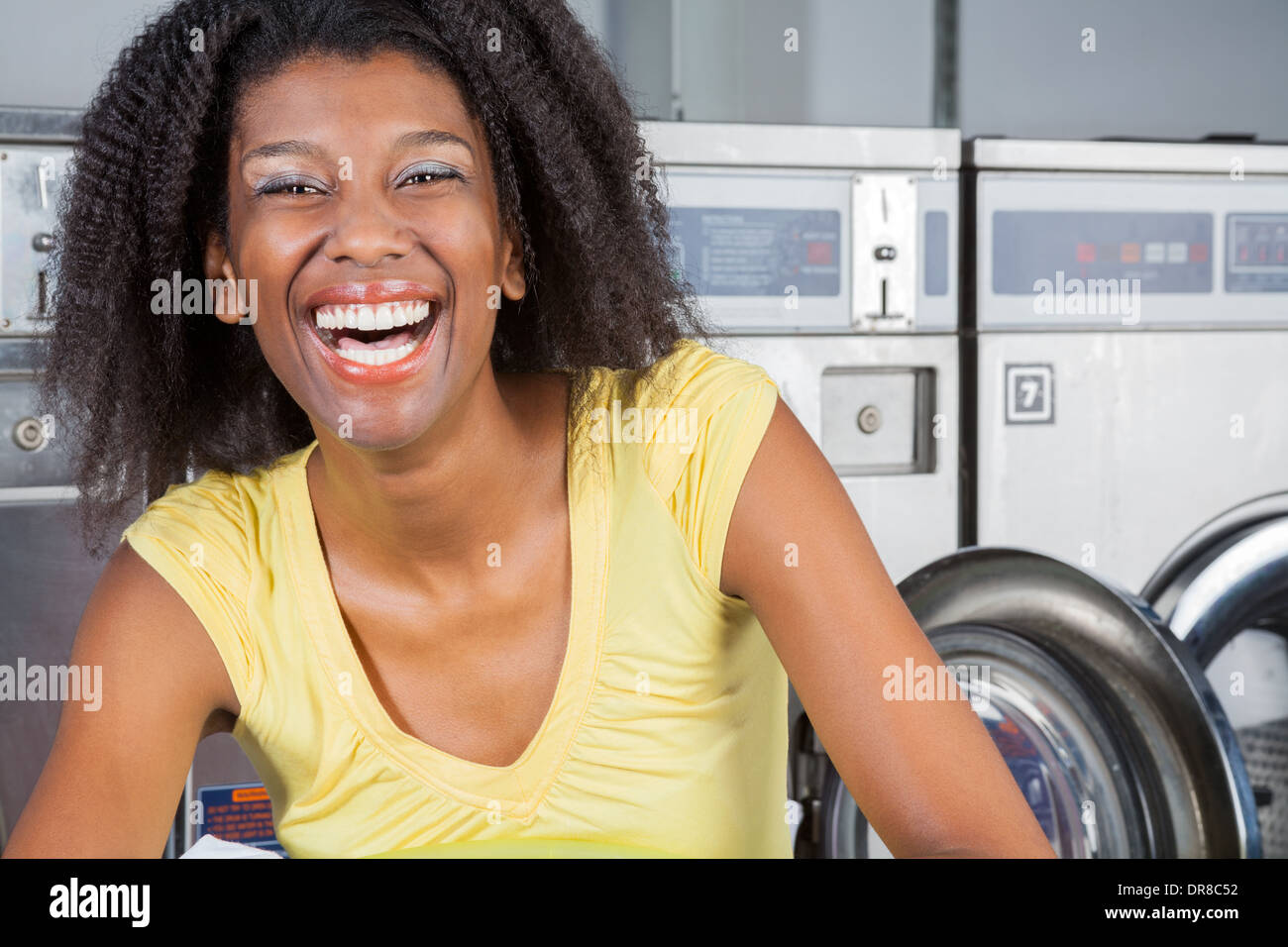 Cheerful Woman In Laundry Stock Photo
