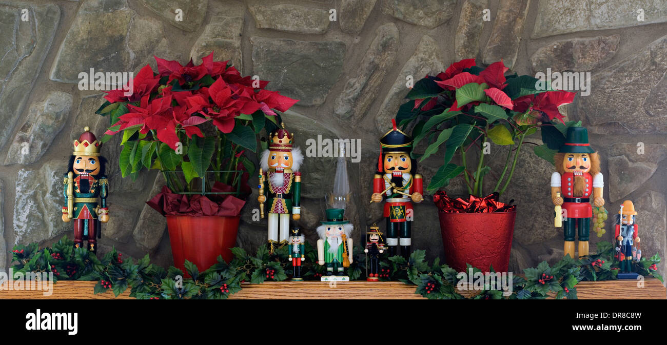 Nutchrackers And Poinsettias Decorating Mantel Stock Photo