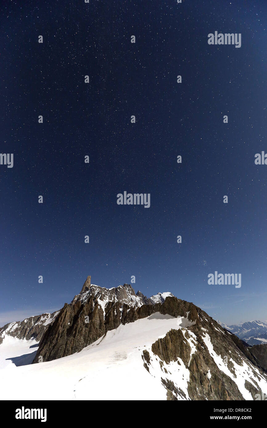 Moonlight on the Dent du Géant mountain peak.The Mont Blanc massif (Monte Bianco). Night landscape, starry sky. Alps. Europe. Stock Photo