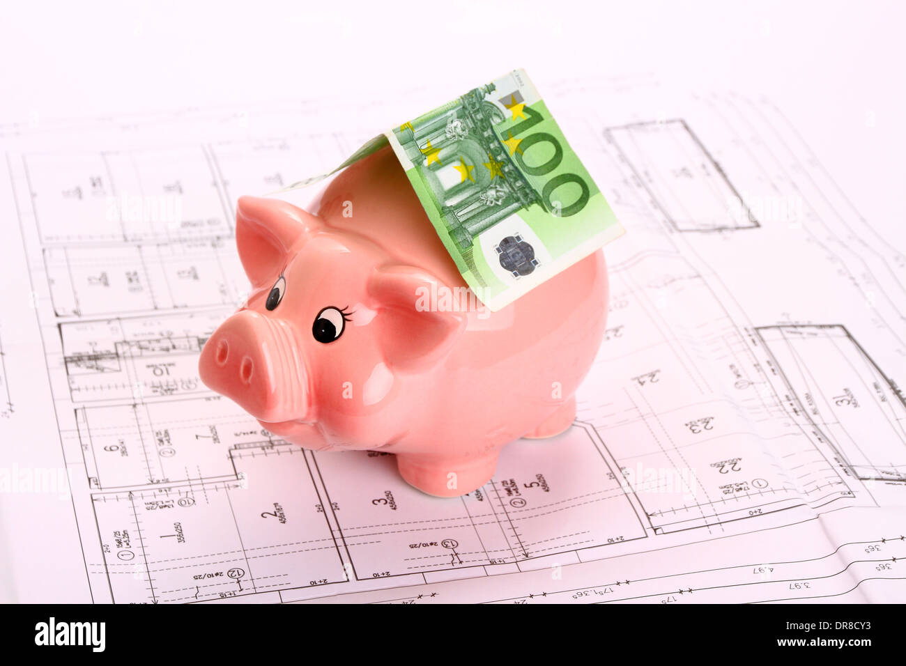 Piggy bank with hundred euro bill as roof on house drawing, top view Stock Photo