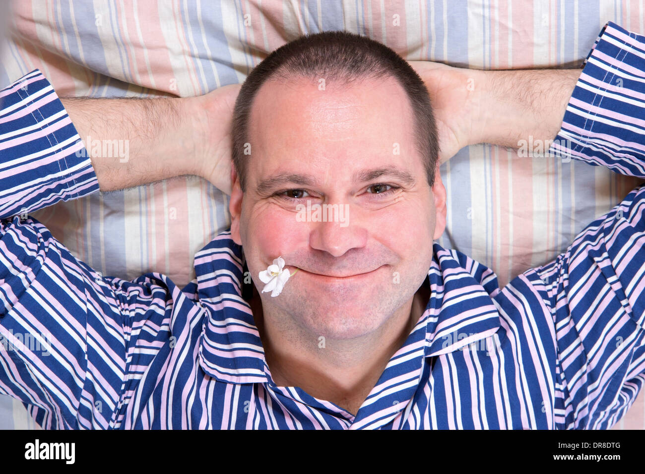 Happy man resting in bed Stock Photo - Alamy