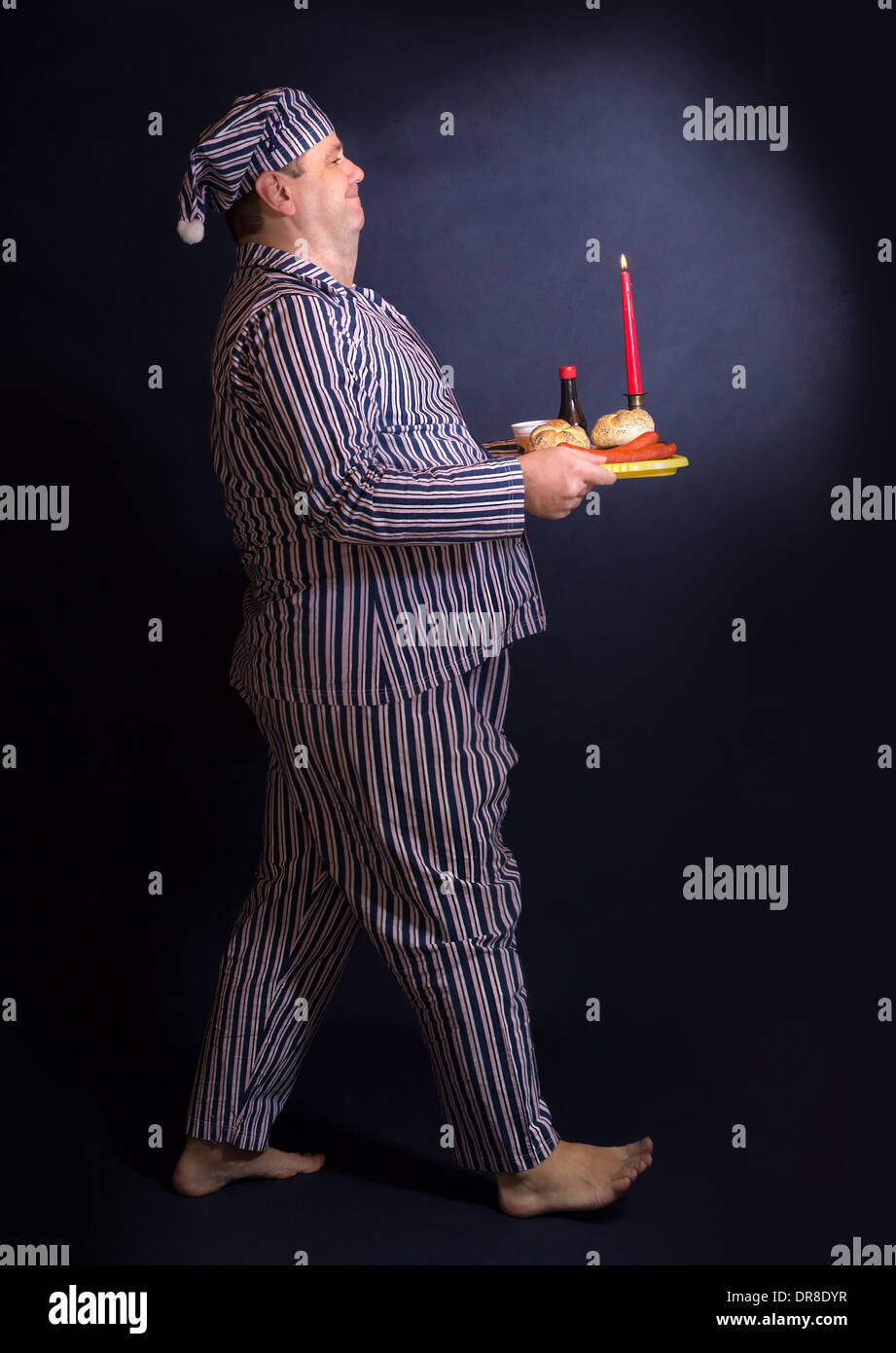 Obese man carries a tray of food Stock Photo
