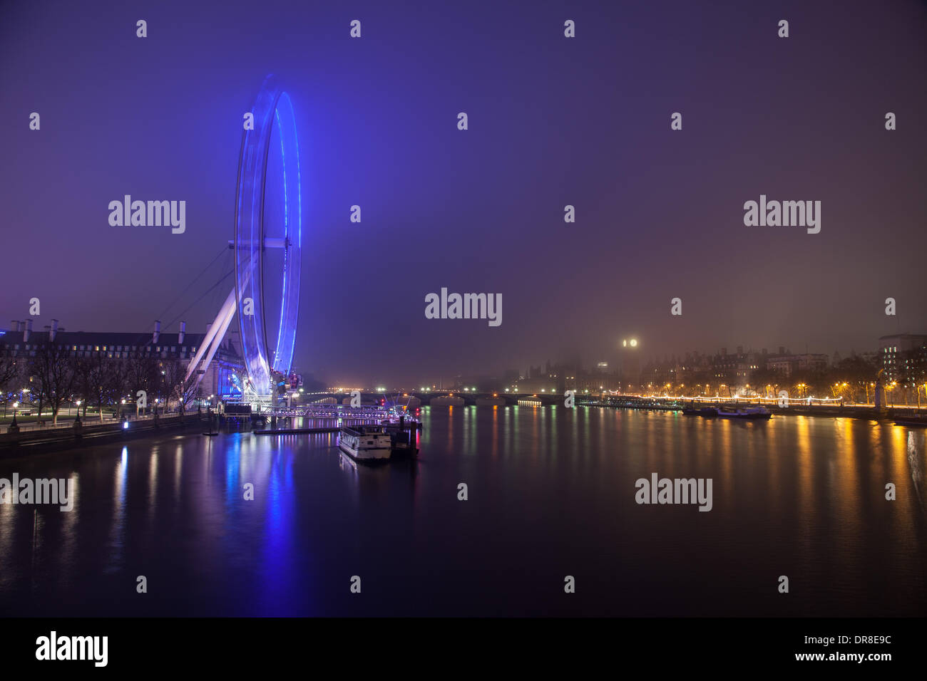 London UK, 21st Jan 2014. The blue lighting of the London Eye lights up the surrounding fog before dawn.  The London Eye is a giant Ferris wheel on the South Bank of the Thames. It was opened in 2000 and is 135m high. © Steve Bright/Alamy Live News Credit:  Steve Bright/Alamy Live News Stock Photo