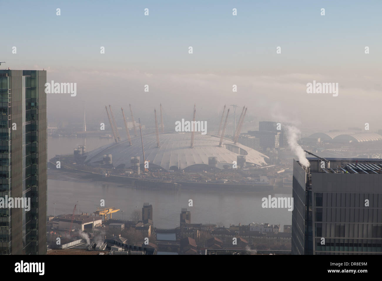 London UK, 21st Jan 2014. The early morning fog disperses revealing the O2 Arena on the Greenwich Peninsula. Dense fog to the east is still visible. This was shot from 1 Canada Square in Canary Wharf. © Steve Bright/Alamy Live News Credit:  Steve Bright/Alamy Live News Stock Photo