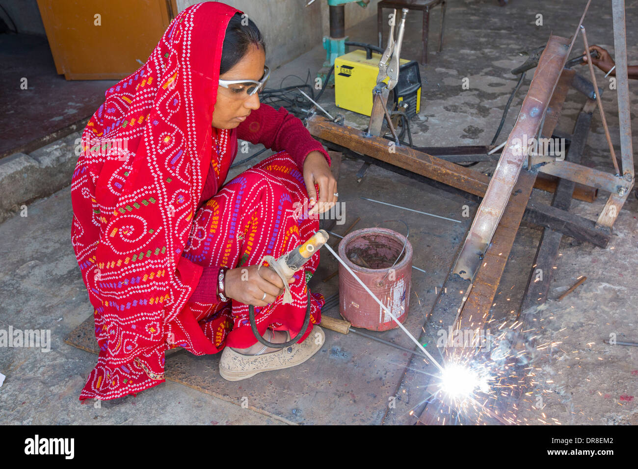 Women welding joints during the construction of solar cookers at the Barefoot College in Tilonia, Rajasthan, India. Stock Photo