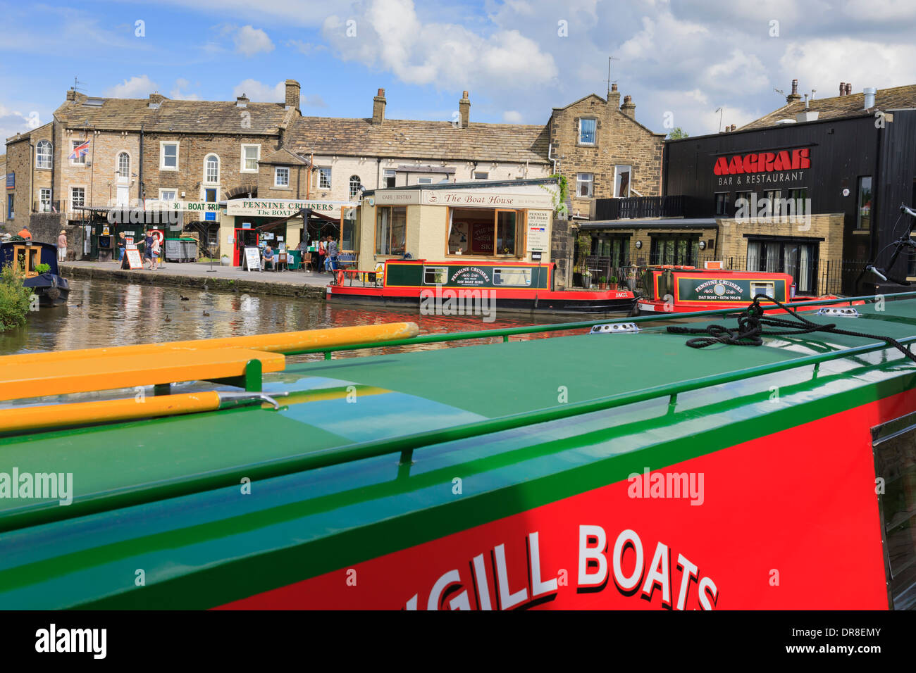 Narrowboats moored by wharf at Leeds and Liverpool Canal Basin Skipton in Craven North Yorkshire England Stock Photo