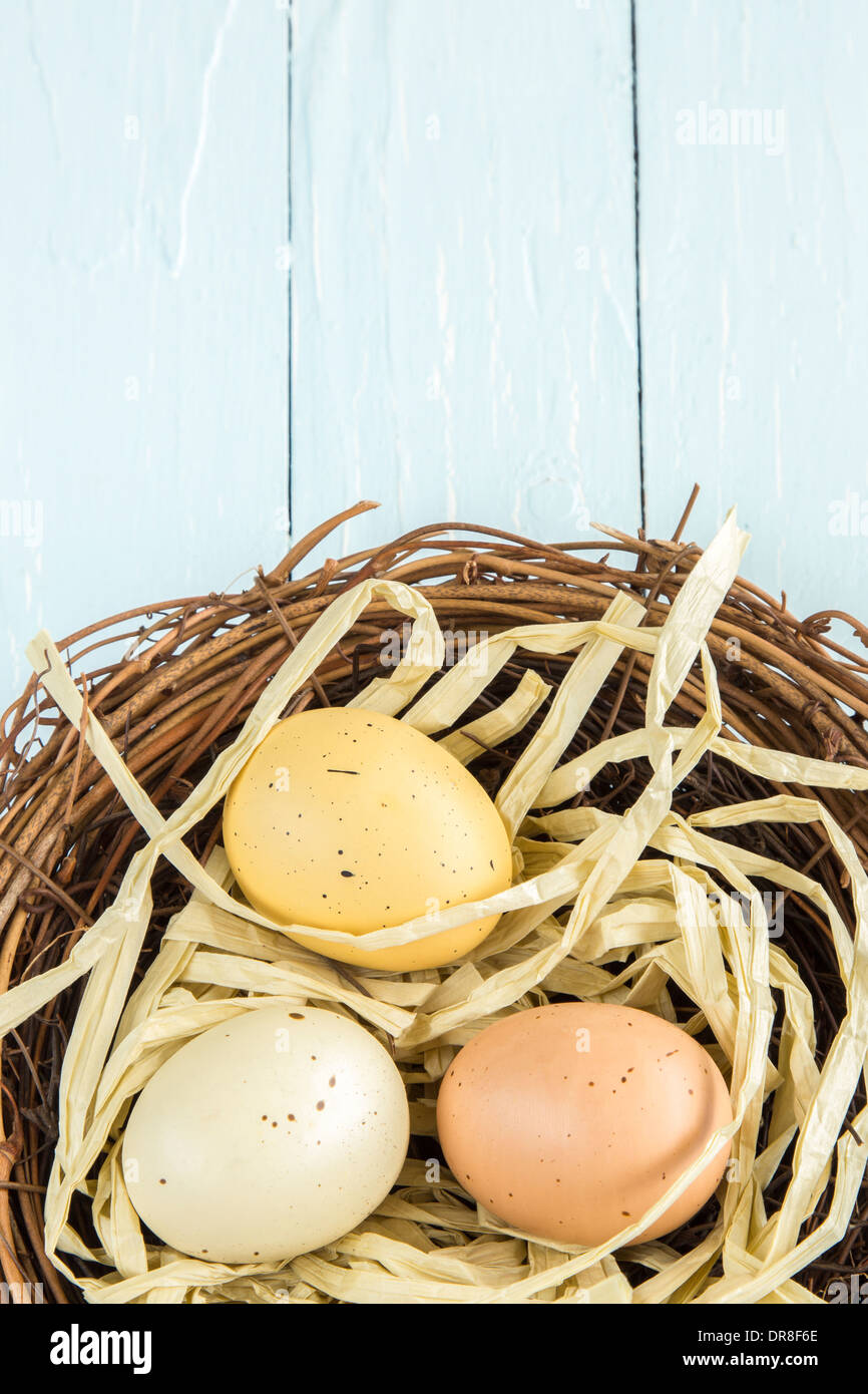 Three colored, spotted eggs in a nest Stock Photo