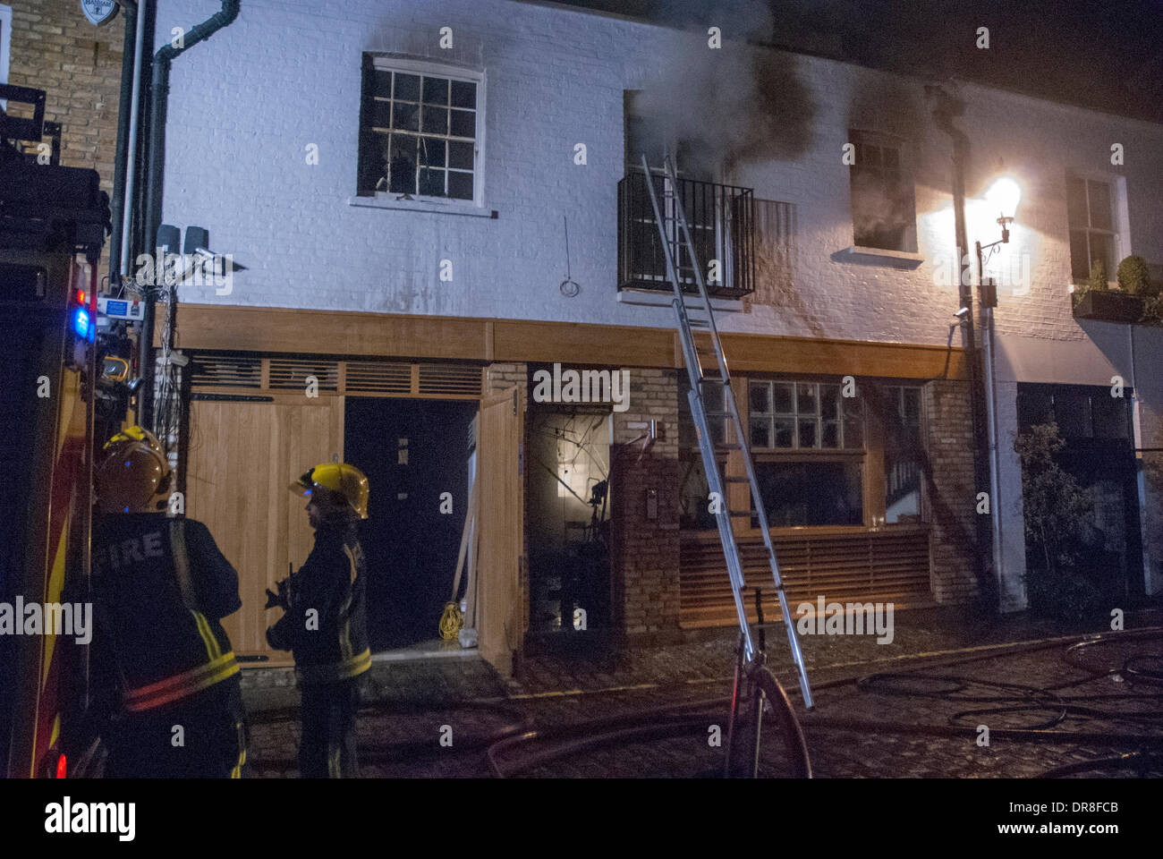 London, UK . 21st Jan, 2014. London Fire Service crew tackle a house