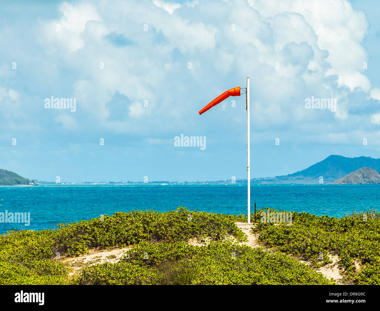 A windsock blowing in the wind above Waimanalo Bay on Oahu, Hawaii Stock Photo