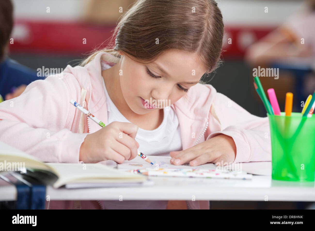 Schoolgirl Drawing At Desk Stock Photo - Alamy