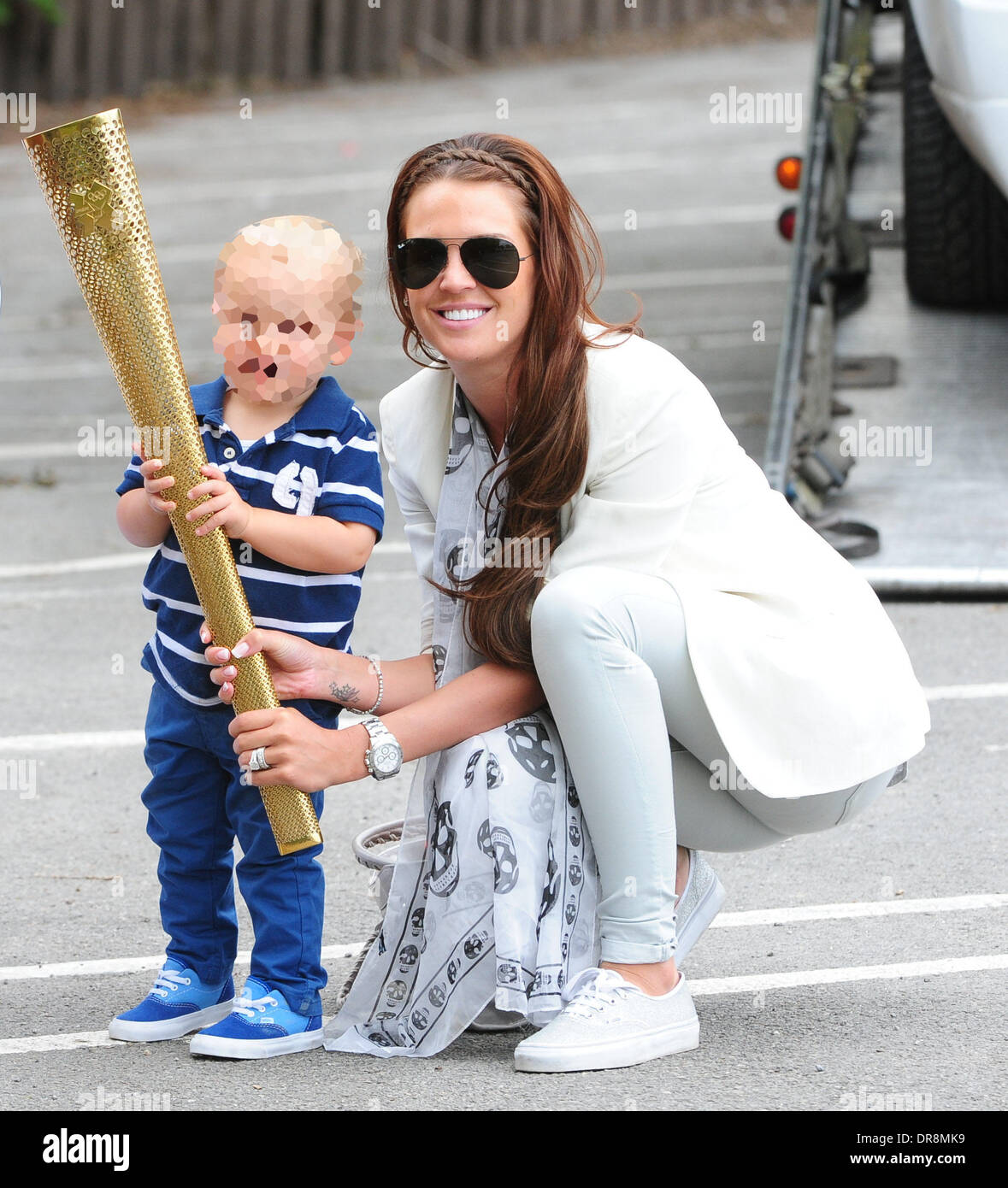 Danielle Lloyd  takes her children to a charity day at Camelot theme park, organised by the Liverpool Taxi drivers association.  Danielle was rescued at the roadside by the AA after her Range Rover broke down. She is also pictured with an Olympic torch bearer's torch Liverpool, England - 20.06.12 Stock Photo