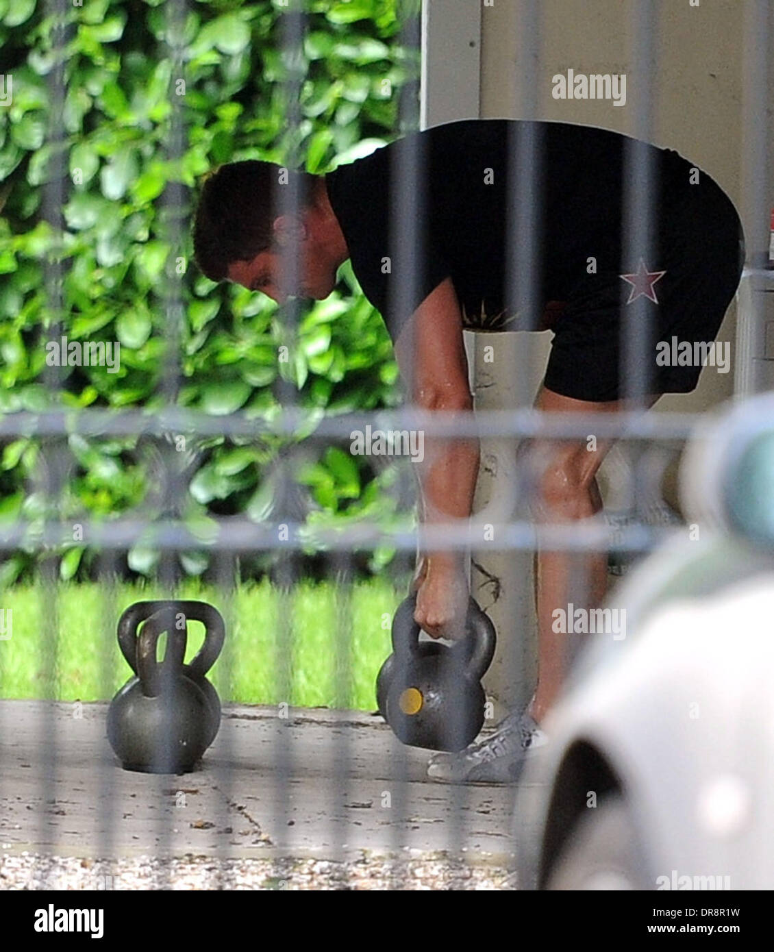 Alex Reid working out in the garage of his home after the recent birth