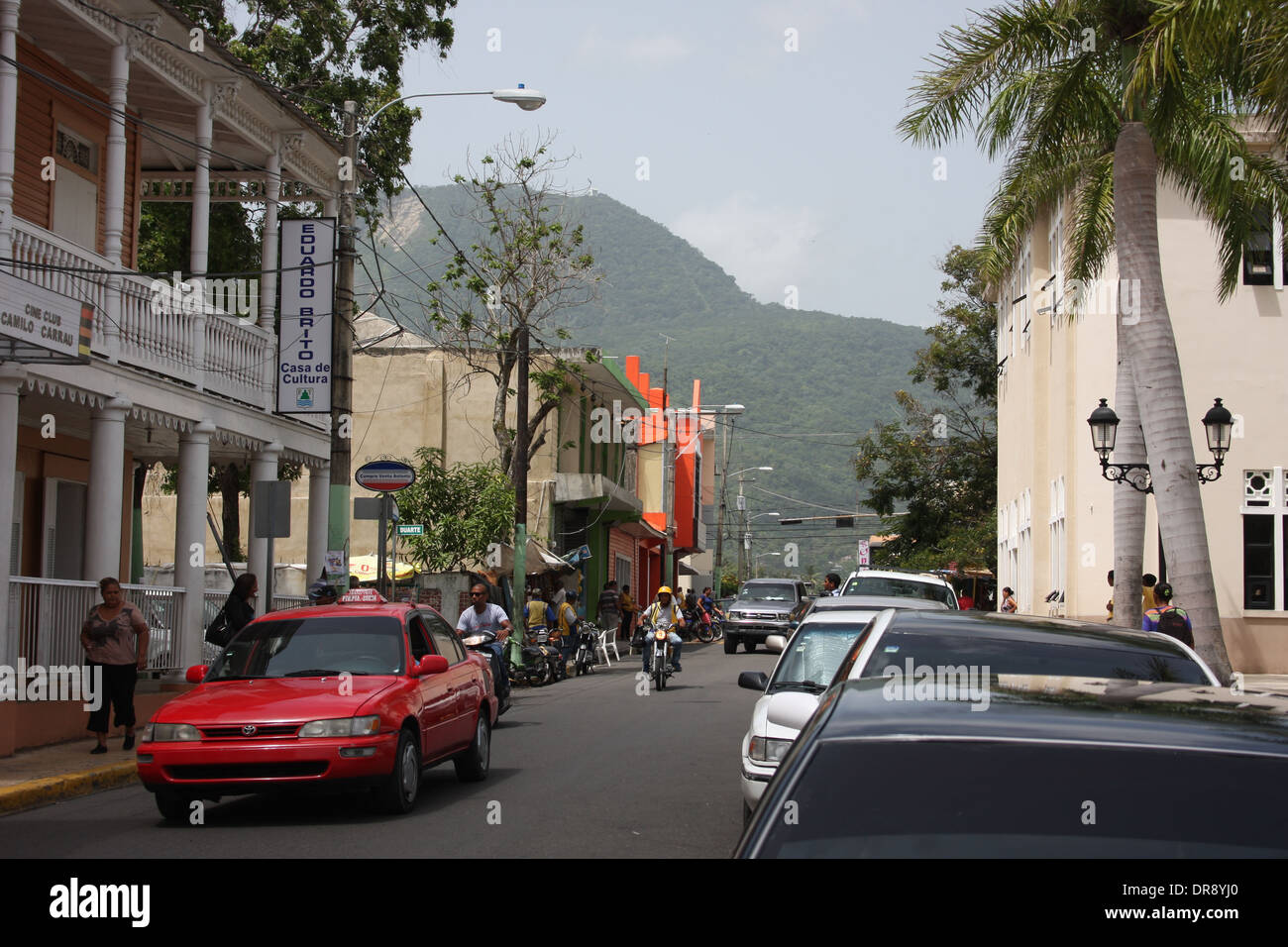 Small urban road in the city of Puerto Plata, Dominican Republic with the mountains in the background Stock Photo