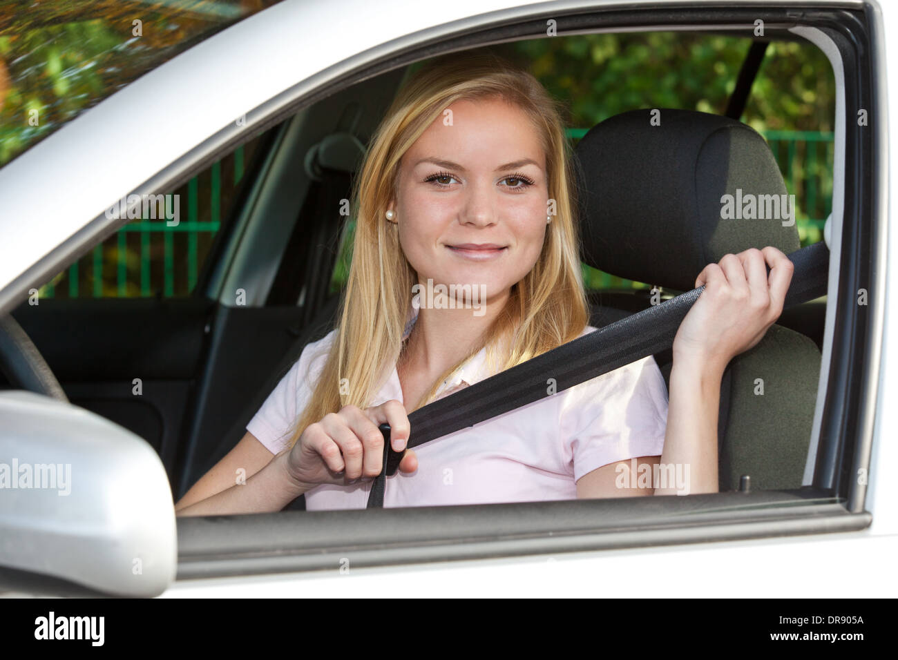 Attractive young woman in her car. Stock Photo
